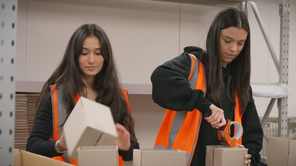 Two employees packing orders at Fulfilment Australia warehouse
